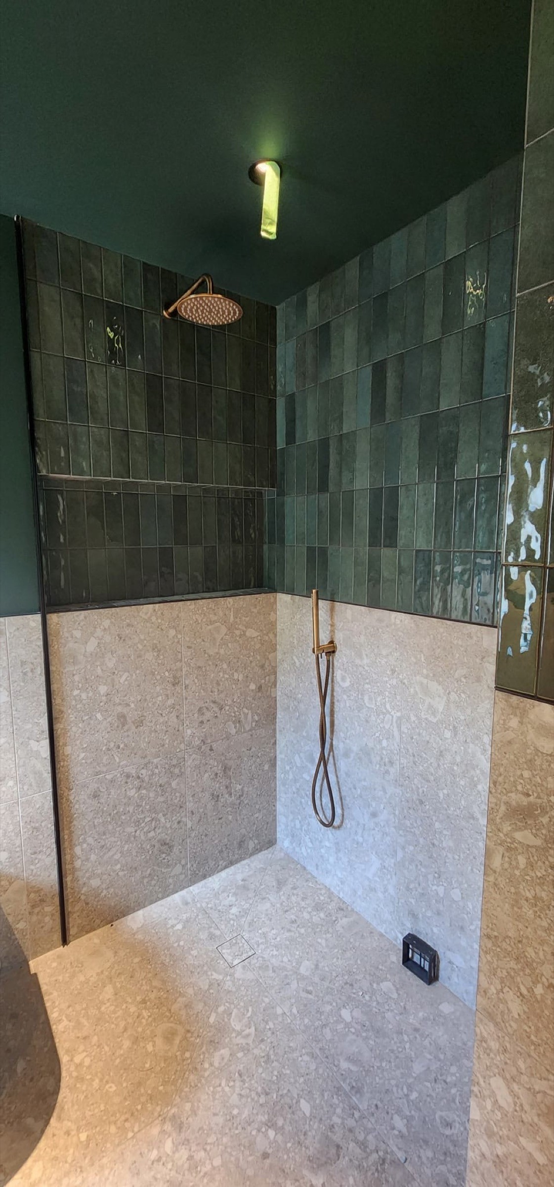 Mallet Tile shower installation with glazed green tile, a recessed niche and large-format stone tile