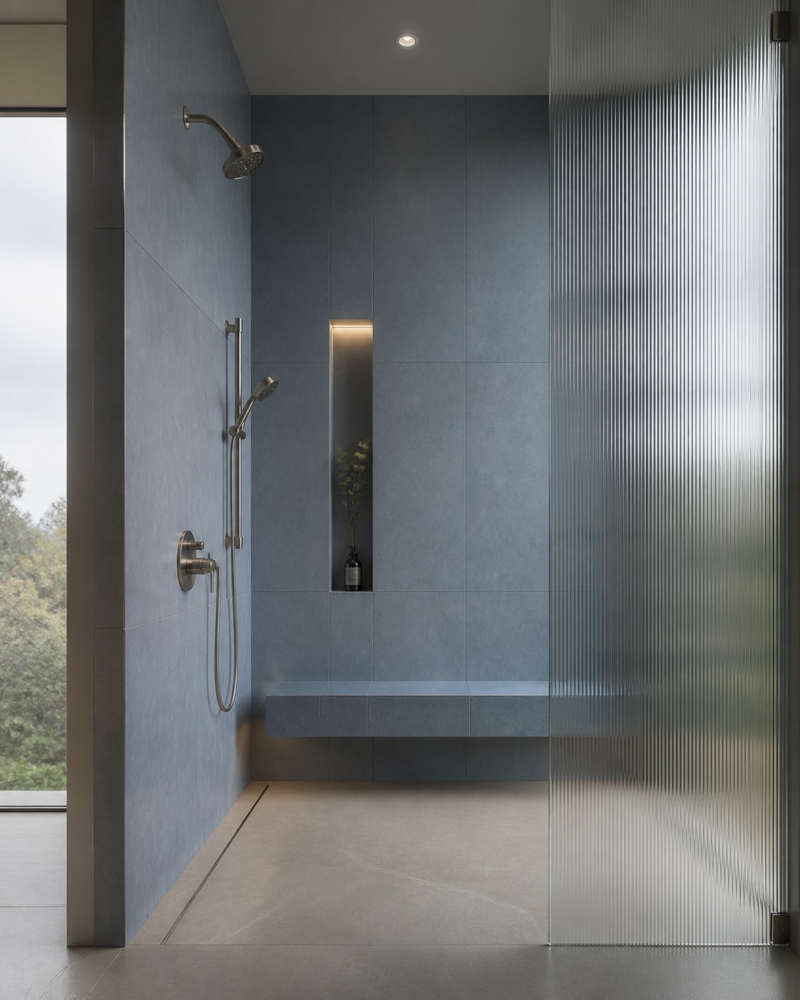 Tall blue-grey shower with fluted glass, a floating bench and slim niche