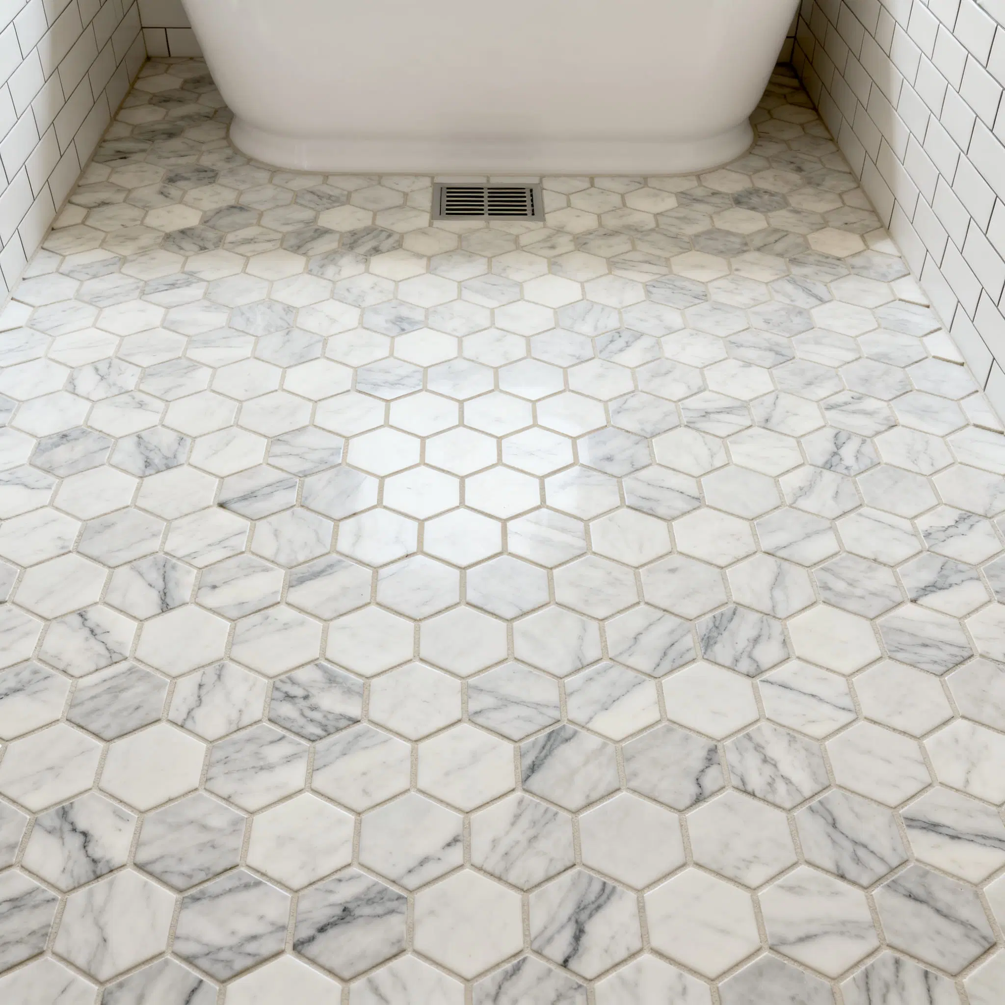 Hexagon mosaic floor showing sheet blending, perimeter cuts and grout joints
